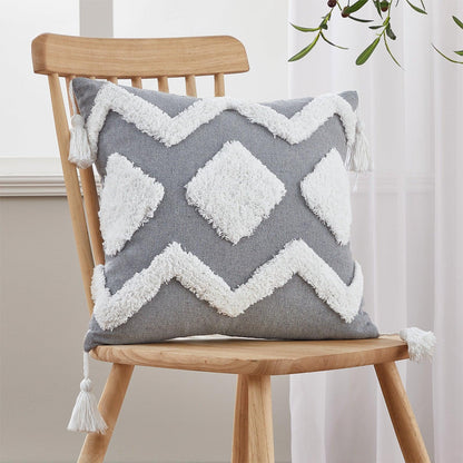 Cushion cover gray cotton-linen with white tufted diamond pattern and tassels on a wooden chair on Tampa Home & Garden Store