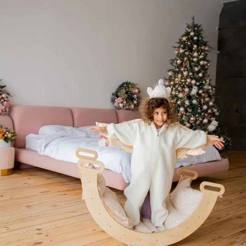 Cream cushion for climbing arch and rocker balance on curved light wood frame with white pillows on Tampa Home & Garden Store