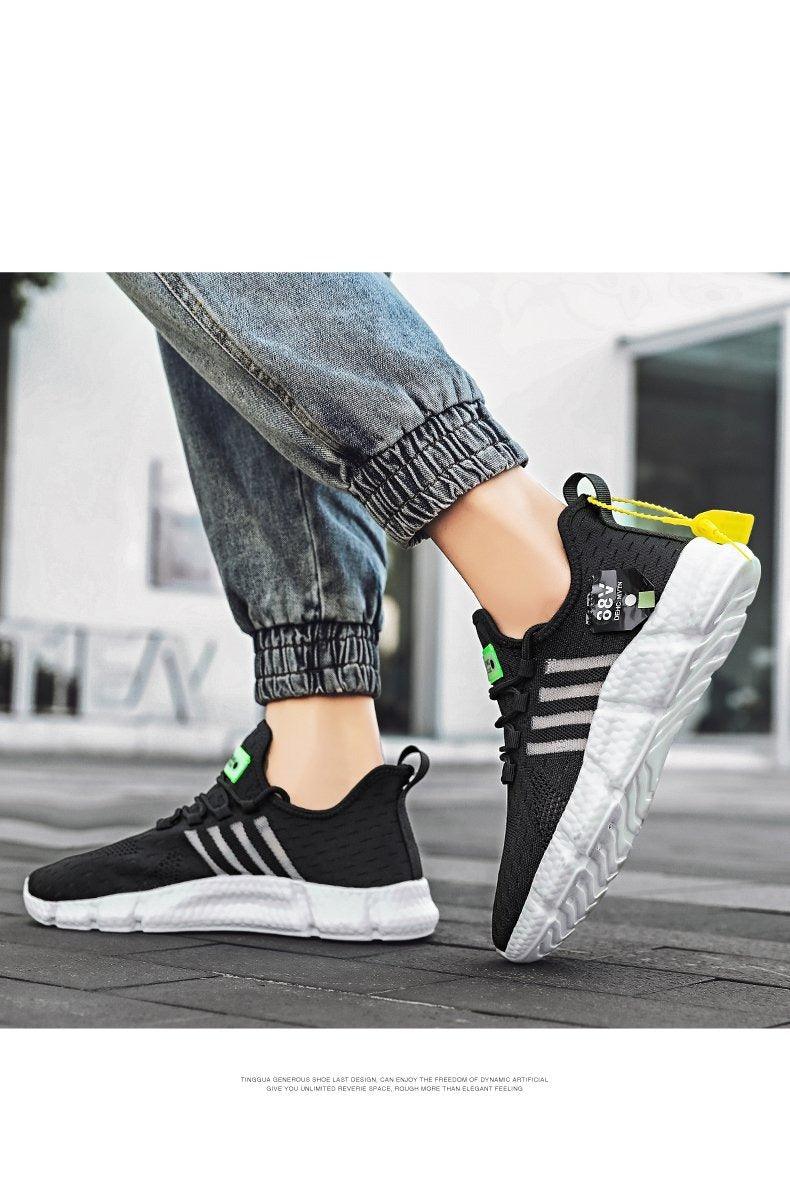 Stevvex men's black mesh running sneakers with white sole and green accents, pair on Tampa Home & Garden Store