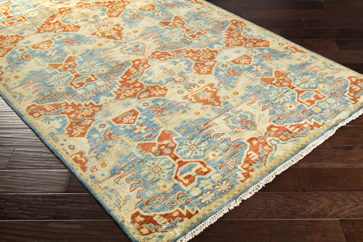 Cutler cream orange wool runner rug by Boutique Rugs with blue fringe on wood floor on Tampa Home & Garden Store