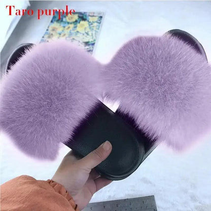 Pair of Stevvex lavender fluffy indoor slippers with large fur pom-poms, slip-on style on Tampa Home & Garden Store