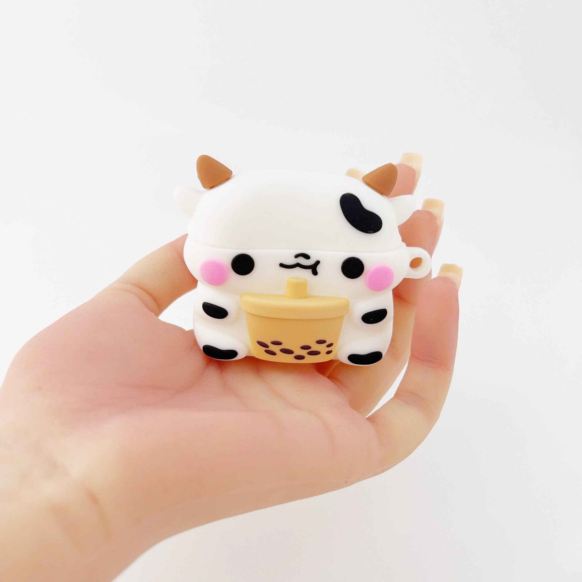Milk cow boba AirPods case held in hand, cow face with horns and bubble tea cup design on Tampa Home & Garden Store