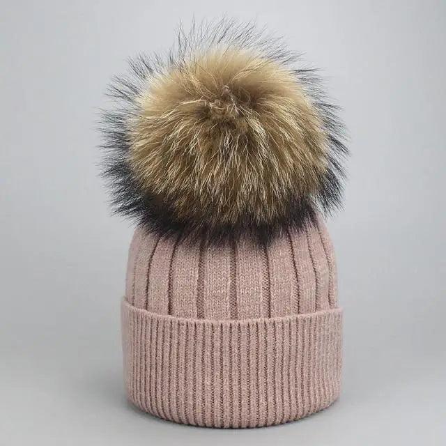 Pink ribbed knit beanie with large tan-to-black faux fur pom-pom for adults and kids on Tampa Home & Garden Store