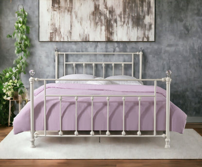 Comet Bed with Elegant Spindle Design white metal panel bed frame with spindle posts lavender bedding against a gray wall on Tampa Home & Garden Store