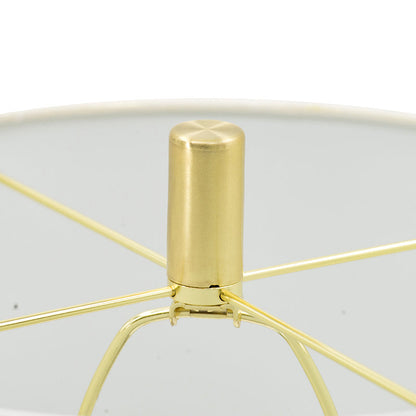 Gold metal table lamp with cylindrical finial and radiating arms above a glass shade on Tampa Home & Garden Store