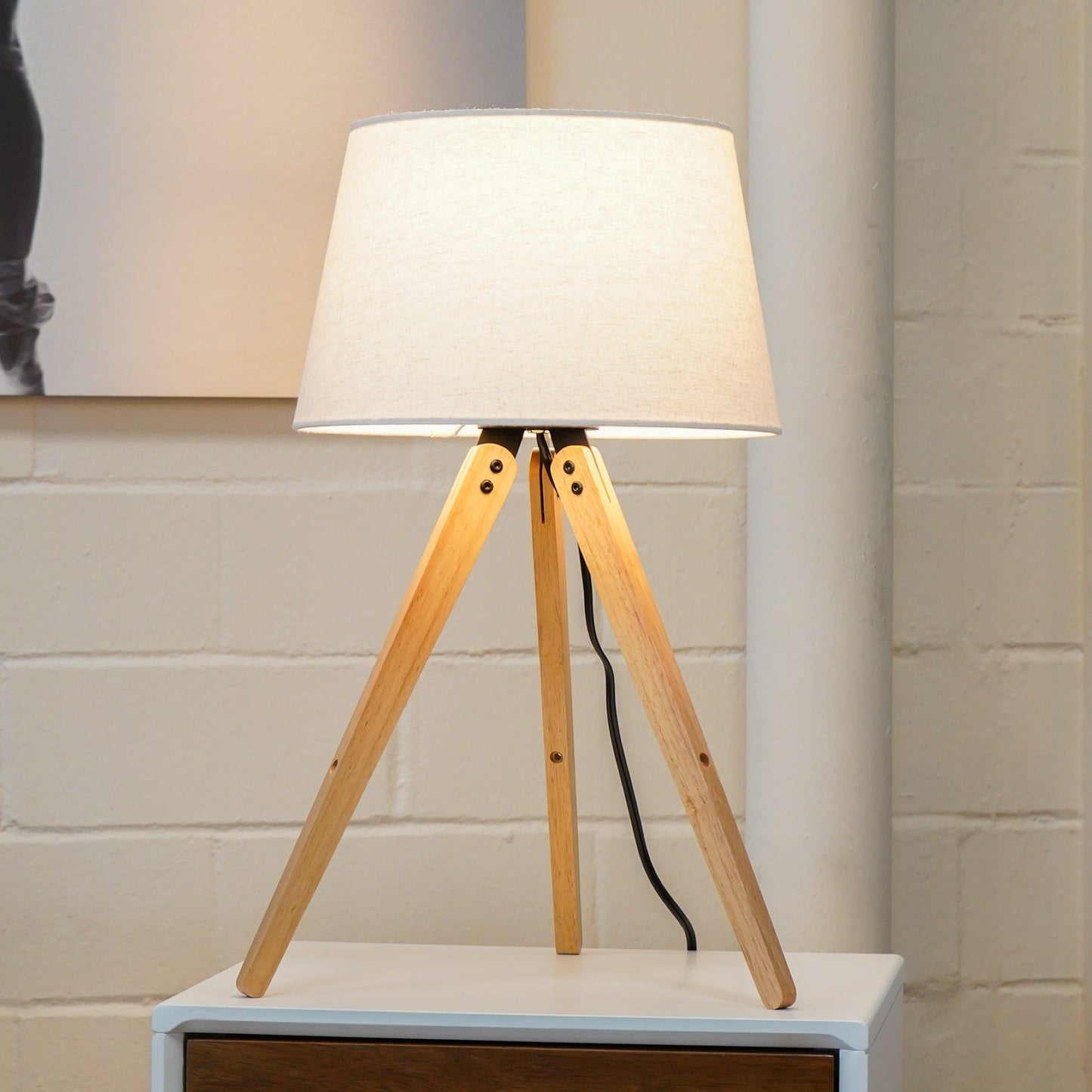 Decorative LED desk lamp with natural wood tripod legs and beige fabric shade on Tampa Home & Garden Store