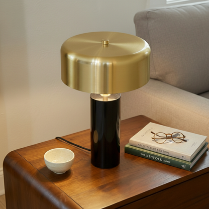 Small Modern Stylish Desk Lamp with gold brass dome and black glossy base on a wooden side table beside three books and glasses on Tampa Home & Garden Store