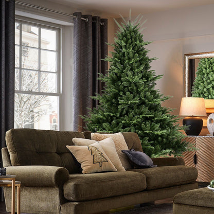 Full-shaped 6 ft Christmas tree HouseOfZazla with 1673 PE/PVC tips in room beside sofa on Tampa Home & Garden Store
