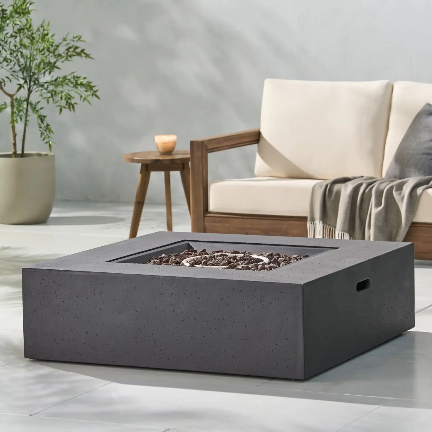 Modern 50,000 Btu square fire table with lava rock fill in dark gray concrete finish on Tampa Home & Garden Store