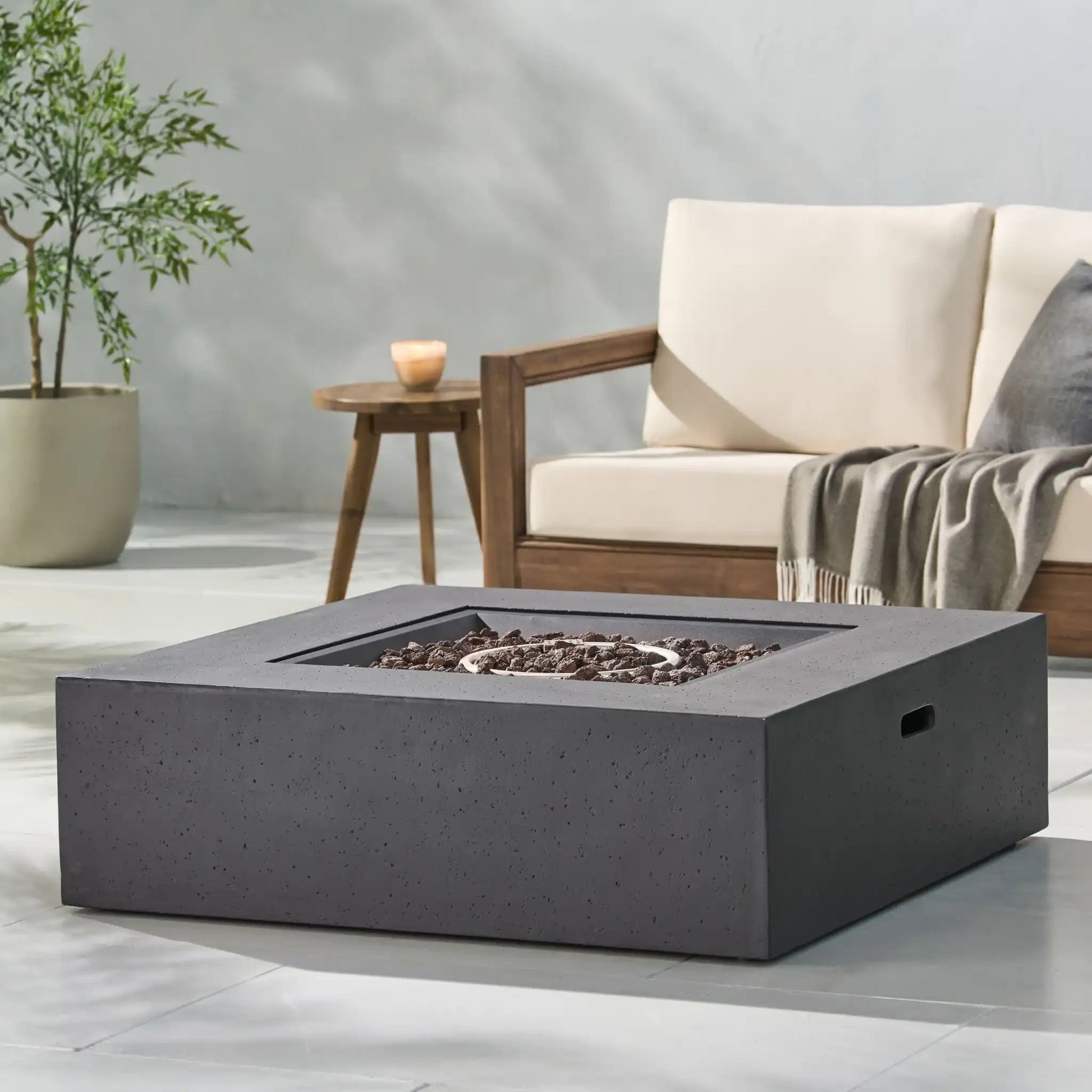 Modern 50,000 Btu square fire table with lava rock fill in dark gray concrete finish on Tampa Home & Garden Store