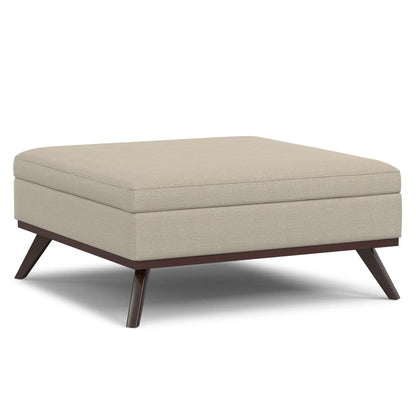 Owen multifunctional square storage ottoman in beige textured fabric with dark wood legs on Tampa Home & Garden Store