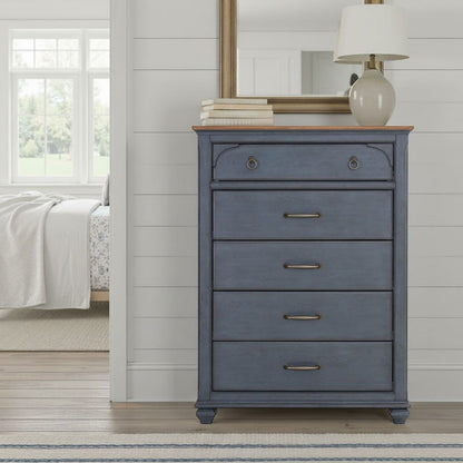 Blue accent chest by HouseOfZazla stacked with books and lamp in a shiplap bedroom on Tampa Home & Garden Store