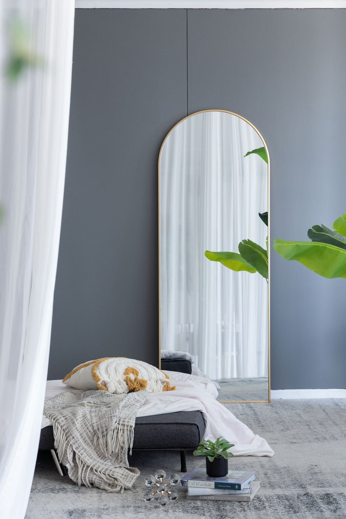 Celine Arch Body Mirror floor mirror with slim gold frame in a grey-walled bedroom on Tampa Home & Garden Store