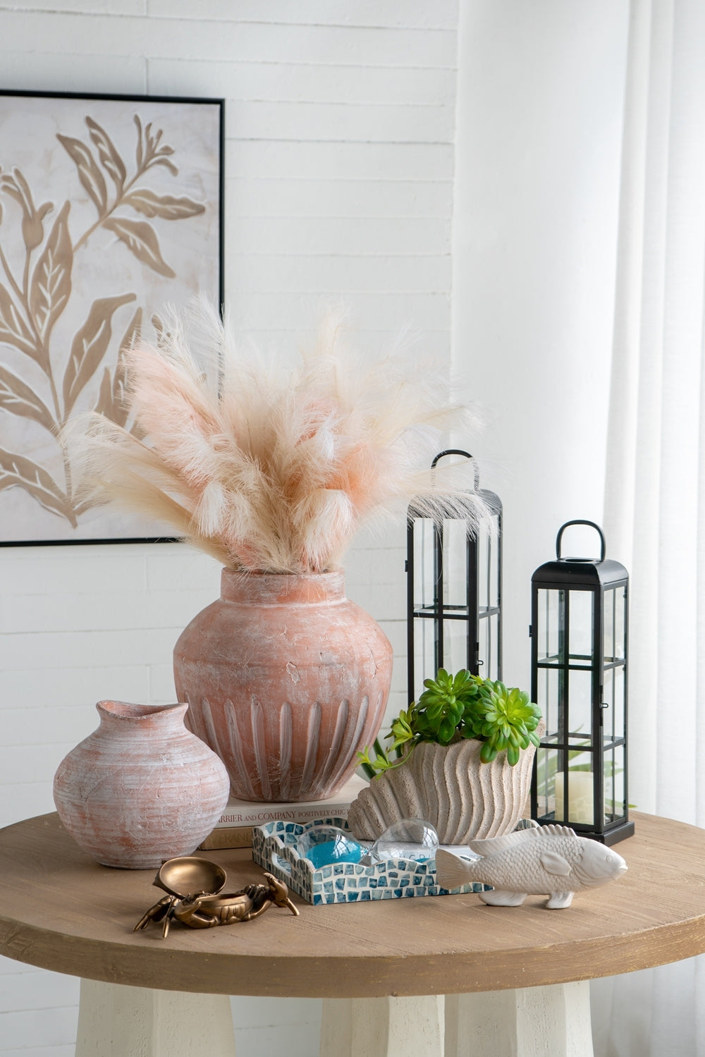 Nautilus shell planter in sand and cement textured beige finish by HouseOfZazla on a round table on Tampa Home & Garden Store