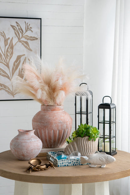 Nautilus shell planter in sand and cement textured beige finish by HouseOfZazla on a round table on Tampa Home & Garden Store