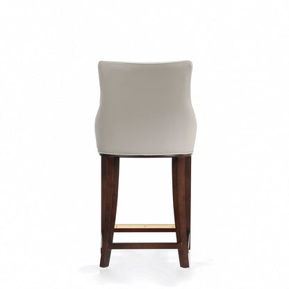 Shubert Counter Stool back view, beige upholstered curved back, dark walnut legs, counter height on Tampa Home & Garden Store