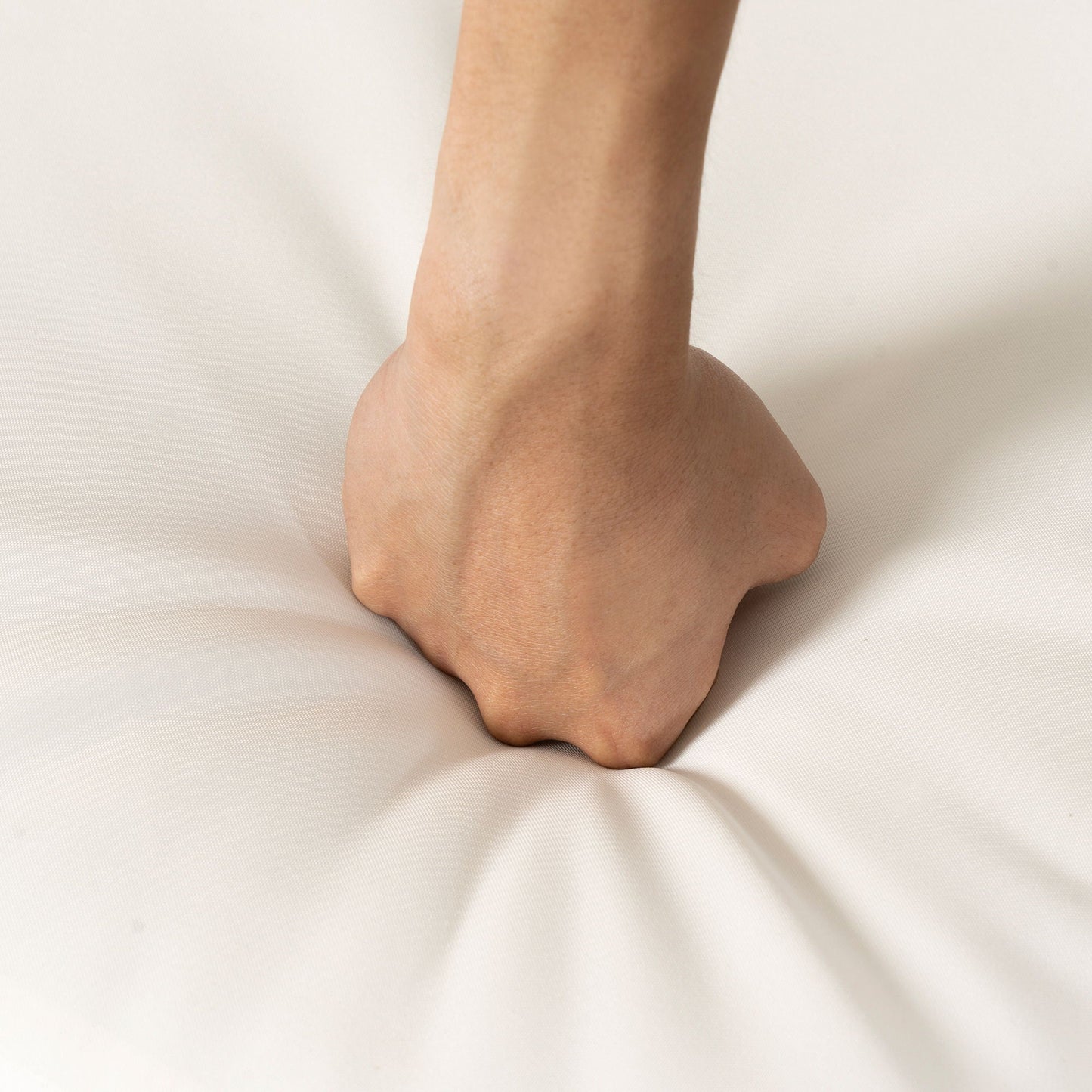 Forearm close-up resting on light beige fabric background on Tampa Home & Garden Store