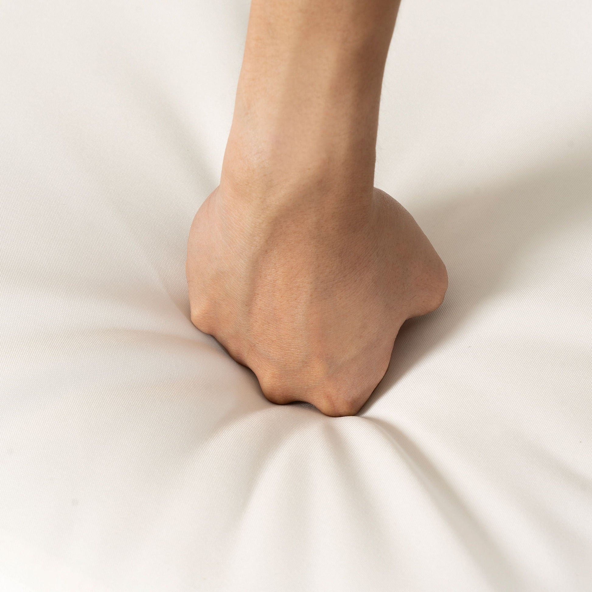 Forearm close-up resting on light beige fabric background on Tampa Home & Garden Store