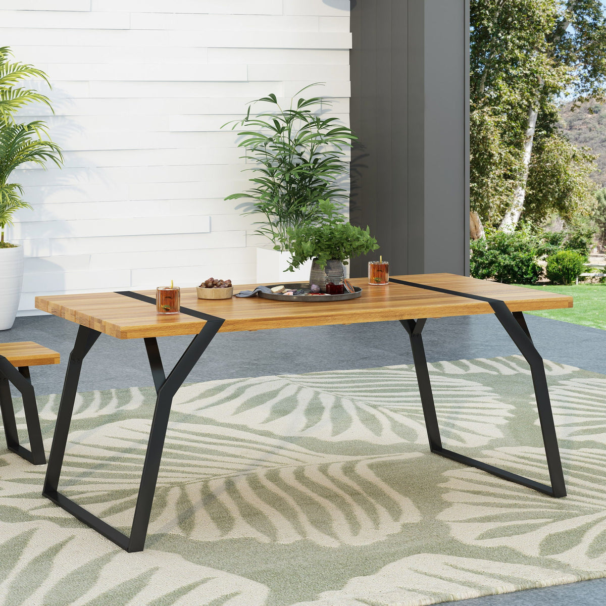 Zora Dining Table with two benches, acacia wood top and black iron legs for outdoor dining on Tampa Home & Garden Store