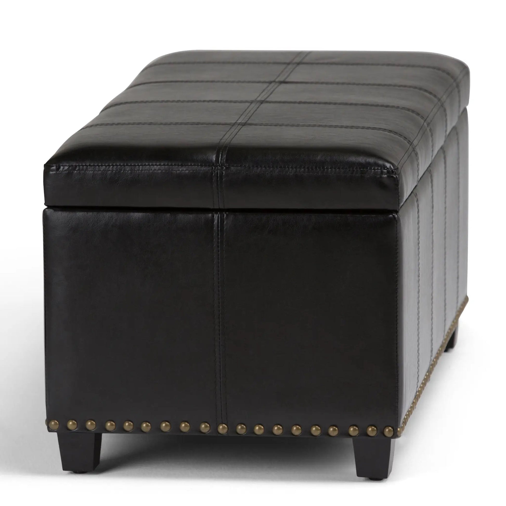 Amelia storage ottoman bench in black leather with grid-stitched top and brass nailhead trim on Tampa Home & Garden Store