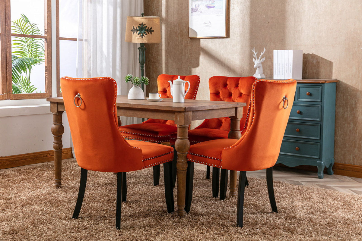 Tufted dining chair set in orange velvet with nailhead trim and dark wood legs on Tampa Home & Garden Store