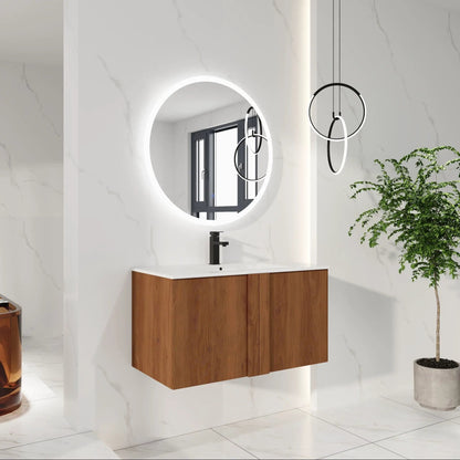 Floating bathroom vanity with sink; white countertop, black faucet; round backlit mirror on Tampa Home & Garden Store