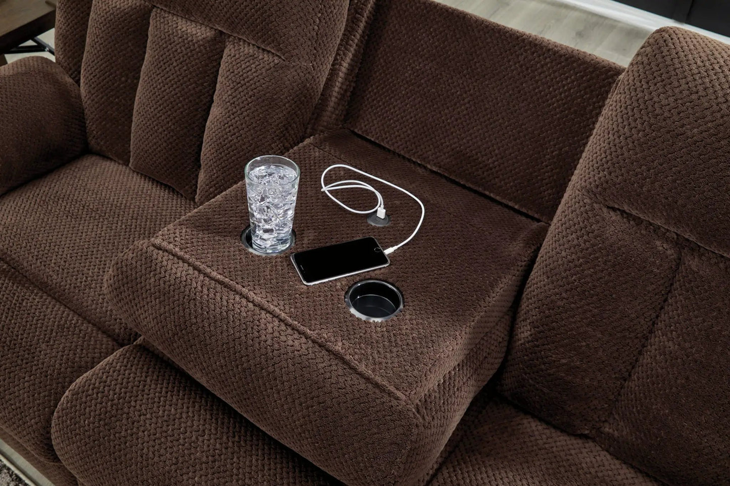 Reclining power sofa in chocolate brown textured fabric with cup holders and charging phone on Tampa Home & Garden Store