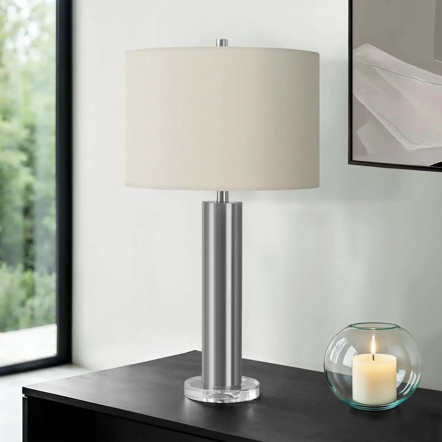 Contemporary table lamp with brushed metal stem, clear acrylic base, and beige fabric shade on Tampa Home & Garden Store