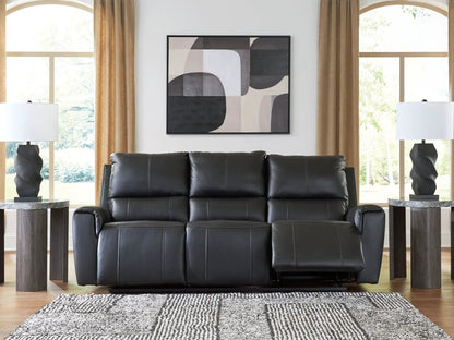 Glossmore reclining sofa in black leather by Unique Piece Furniture in a bright living room on Tampa Home & Garden Store