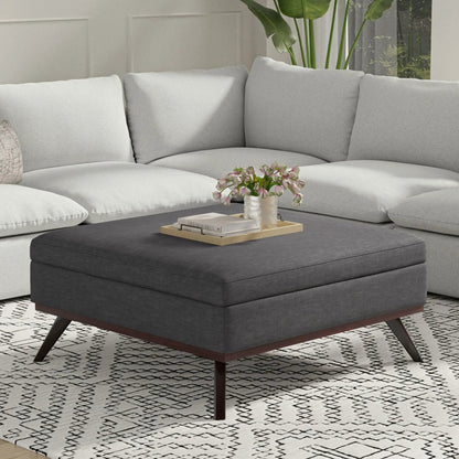 Owen square coffee table storage ottoman in dark gray fabric with wood legs and tray of books on Tampa Home & Garden Store