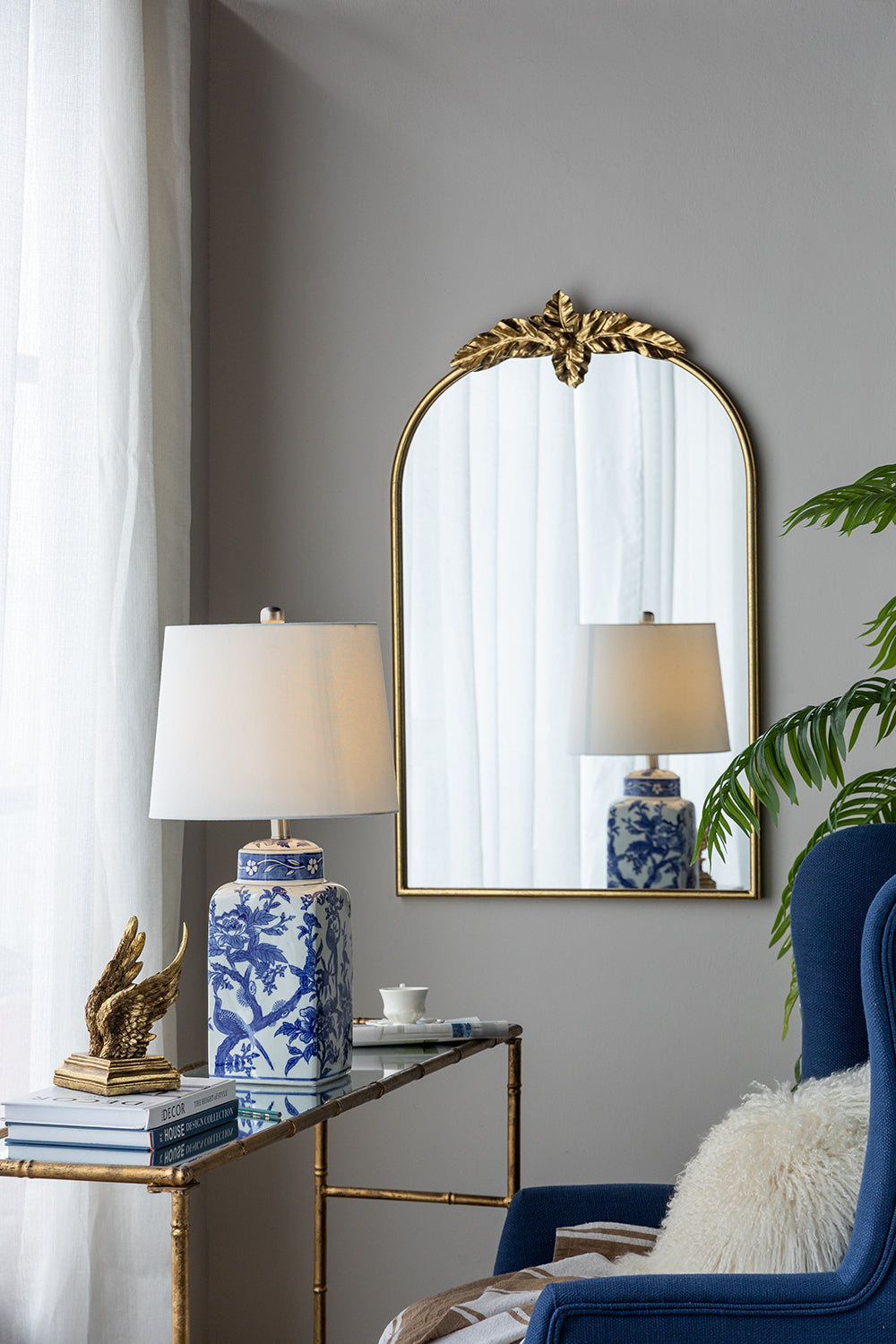 13x25' Blue and White Ceramic Vase Lamp with white shade on a brass console table on Tampa Home & Garden Store