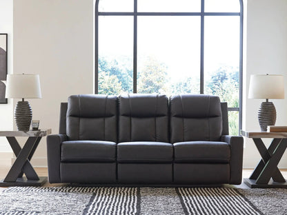 Mackmenville reclining sofa by Unique Piece Furniture in black leather with tufted cushions on Tampa Home & Garden Store