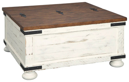 Wystfield cocktail table with storage, white distressed base and brown wood top, bun feet on Tampa Home & Garden Store