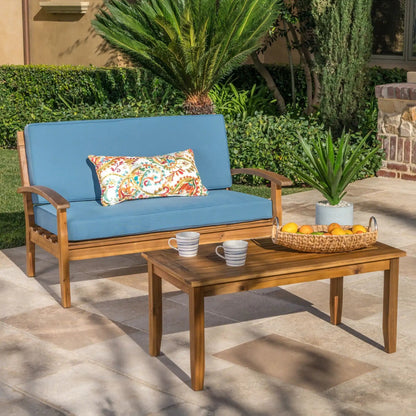 2-piece chat set with blue cushions loveseat and coffee table in a yard; fruit and mugs on Tampa Home & Garden Store