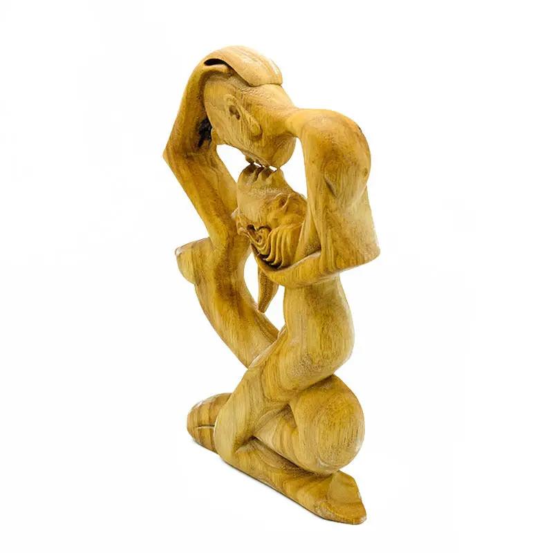 Wooden Love Eternal Valentine sculpture showing kneeling lovers with a baby between them on Tampa Home & Garden Store