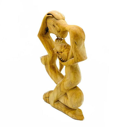 Wooden Love Eternal Valentine sculpture showing kneeling lovers with a baby between them on Tampa Home & Garden Store