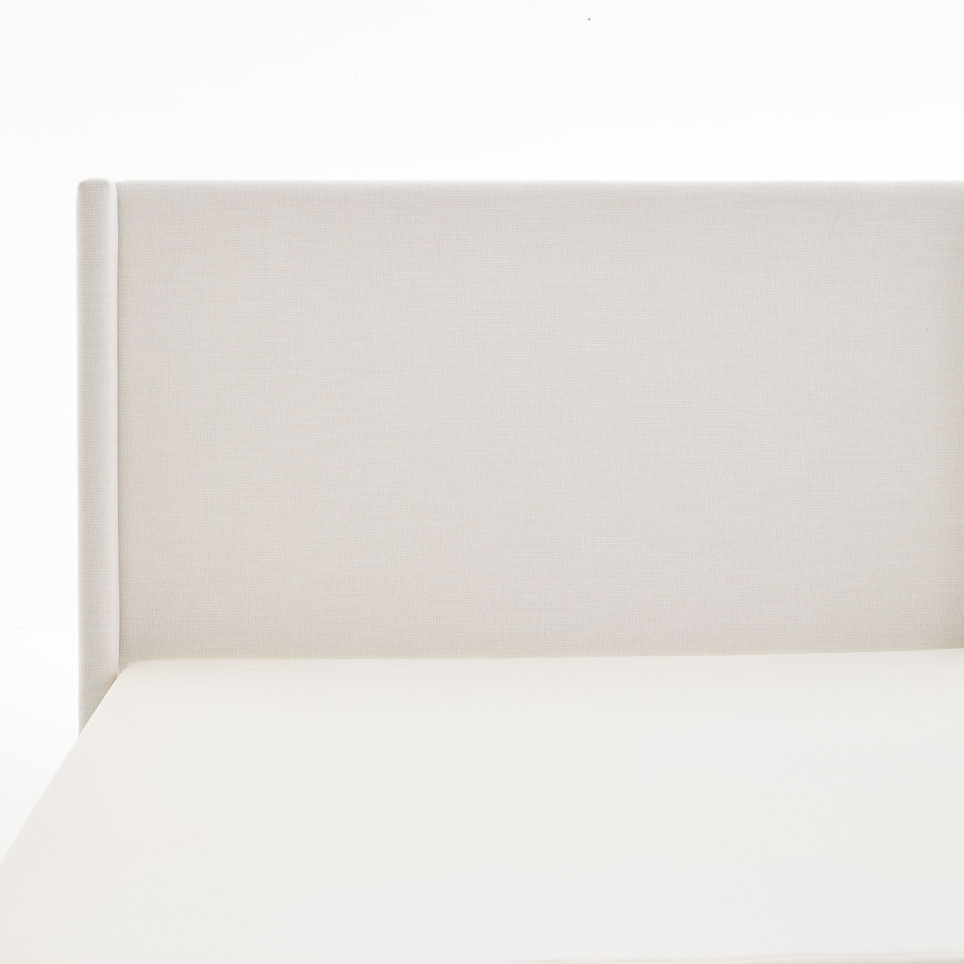 Hosford minimalist upholstered wingback bed headboard in cream fabric, close-up on Tampa Home & Garden Store