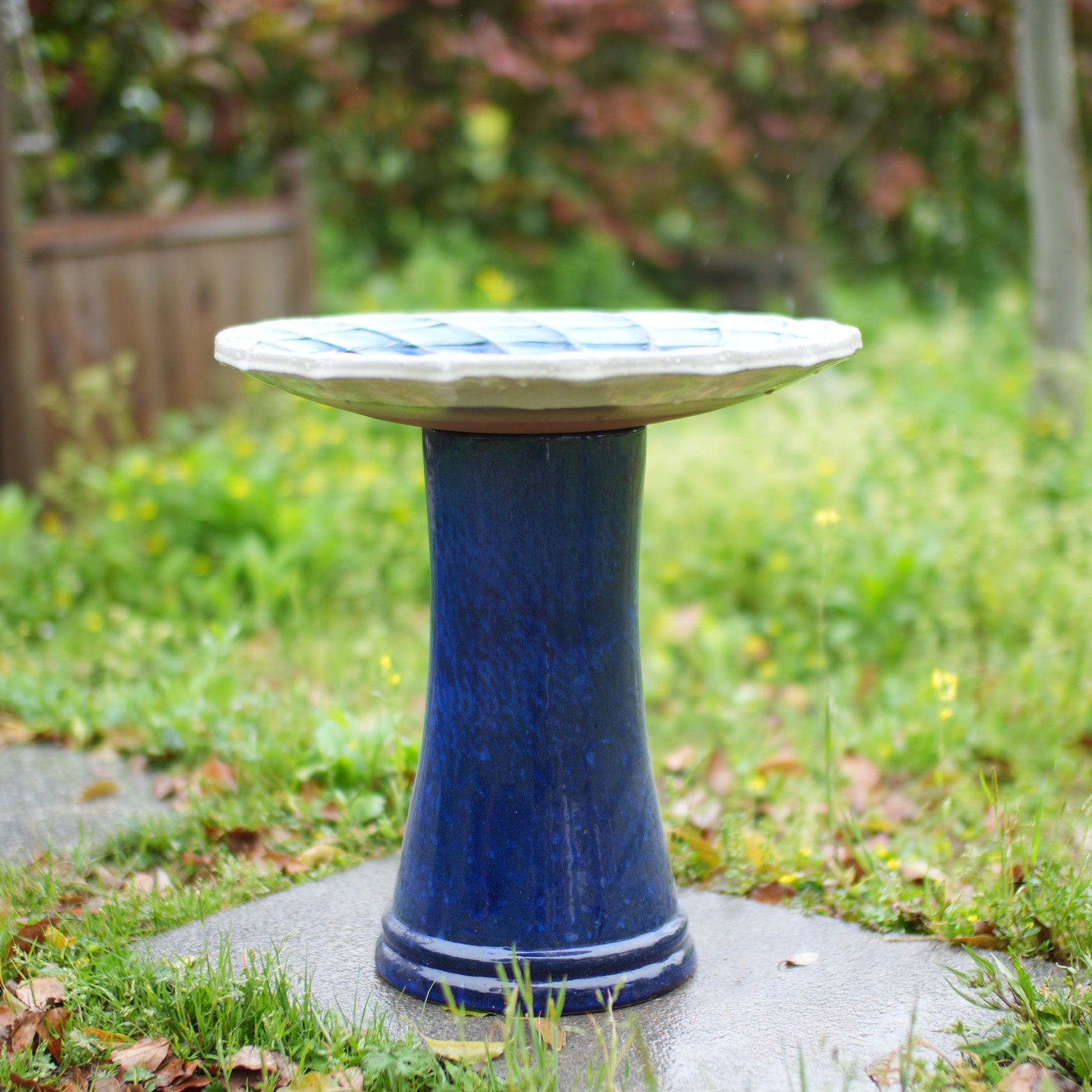 Handmade glazed ceramic bird bath on a blue pedestal with pale blue and white rim on Tampa Home & Garden Store