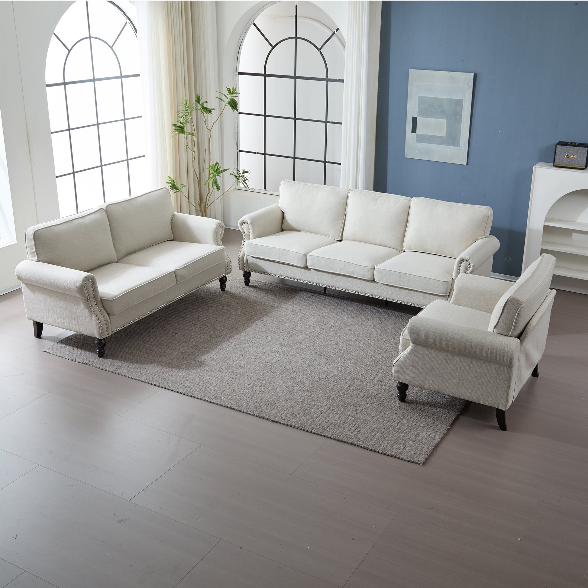 68 Inch rolled-arm sofa in light gray fabric with nailhead trim in a modern living room setup on Tampa Home & Garden Store