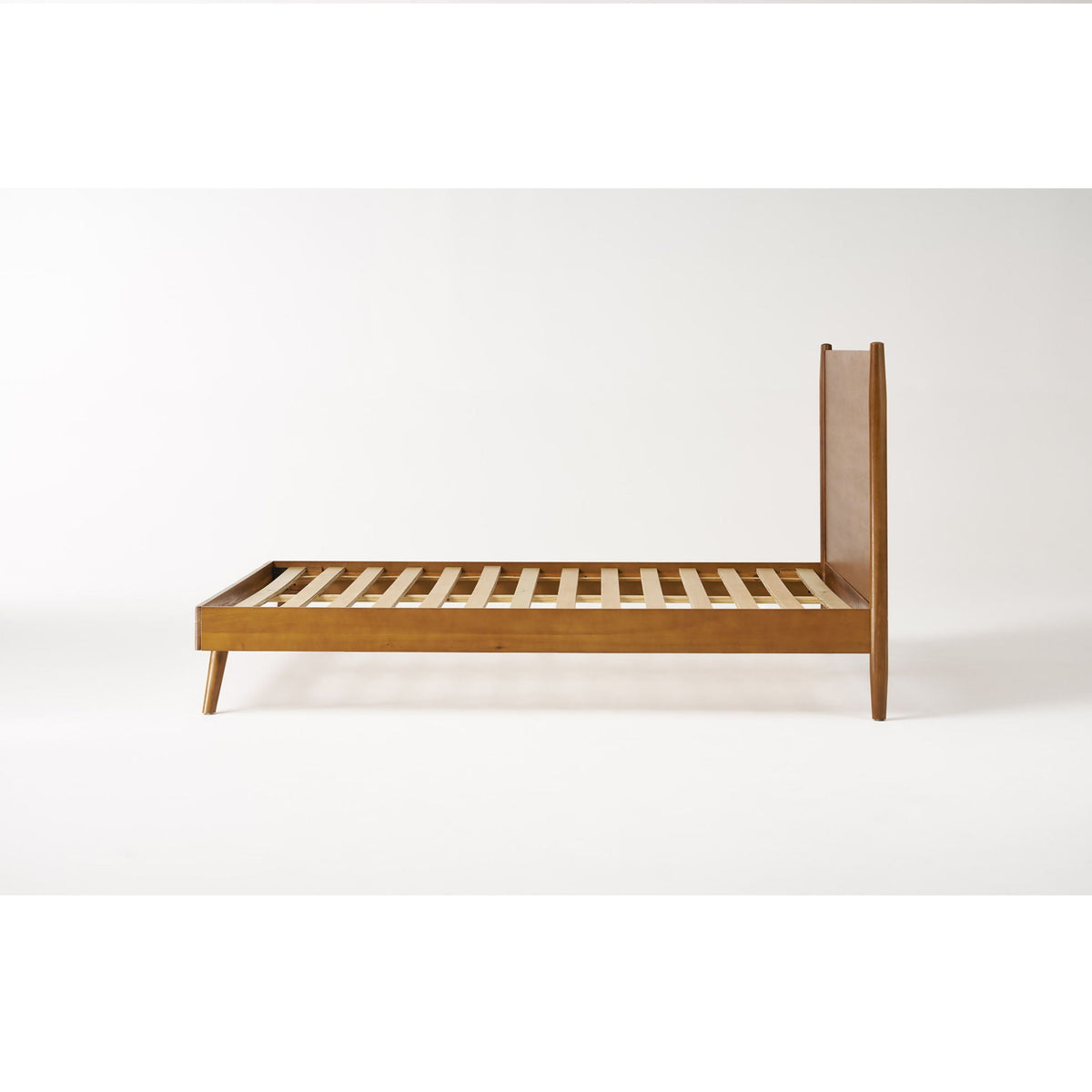 Mid-Century wooden platform bed frame in light brown with slatted base and slender legs on Tampa Home & Garden Store