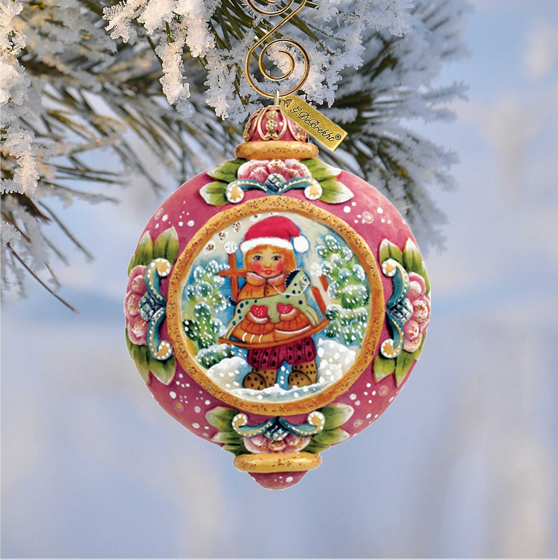 G. DeBrekht hand-painted Christmas Gift Sculpted Ornament with pink panel and gold trim on snow on Tampa Home & Garden Store