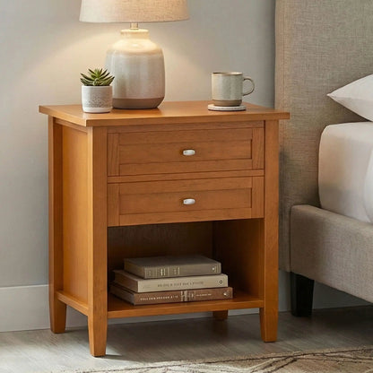 Warm Shaker bedside table in wood finish with three drawers topped by lamp, plant, and mug on Tampa Home & Garden Store