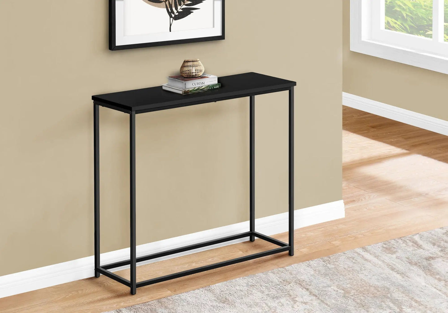 Accent console table with black metal frame in entryway, books and wicker lamp on Tampa Home & Garden Store