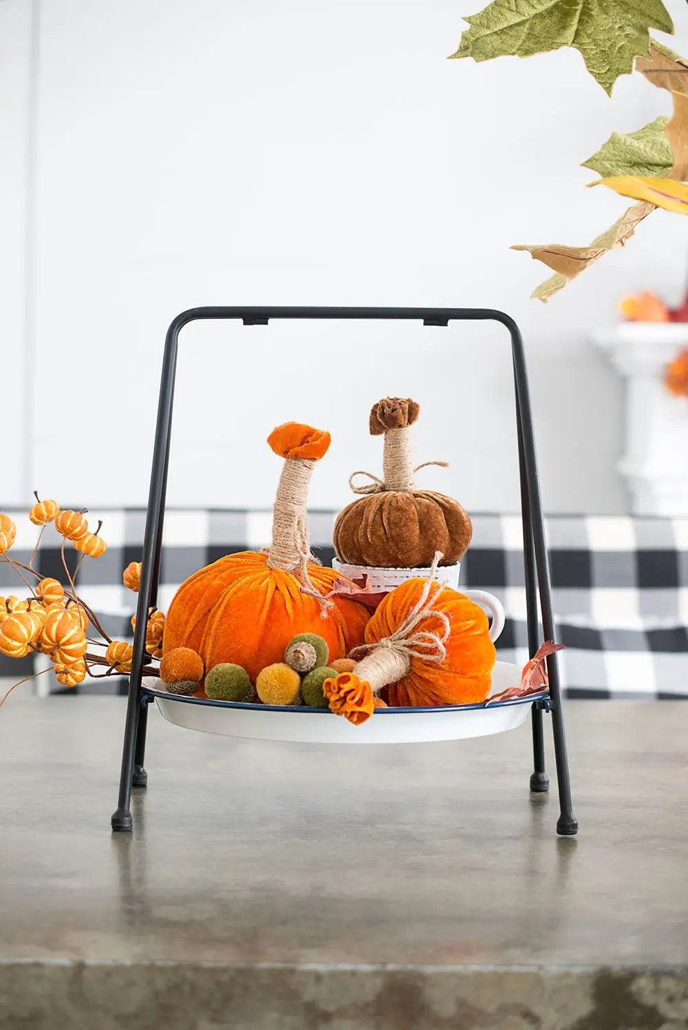 Unique Piece Furniture Pumpkin Ornament set of 6 on a white dish with a black metal stand; orange fabric pumpkins with twine stems on Tampa Home & Garden Store