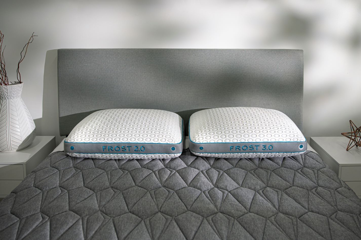BedGear Frost 2.0 & 3.0 cooling pillows, white quilted covers with blue trim on gray bed on Tampa Home & Garden Store