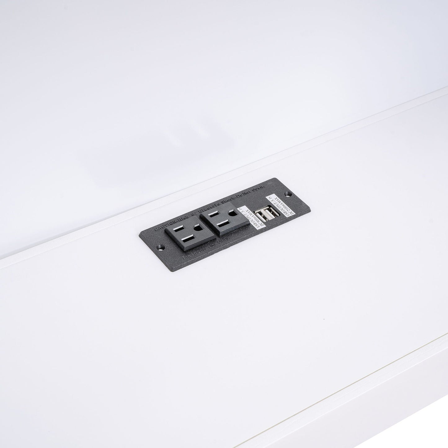 Black electrical outlet plate with USB ports and two outlets on white bed frame surface on Tampa Home & Garden Store