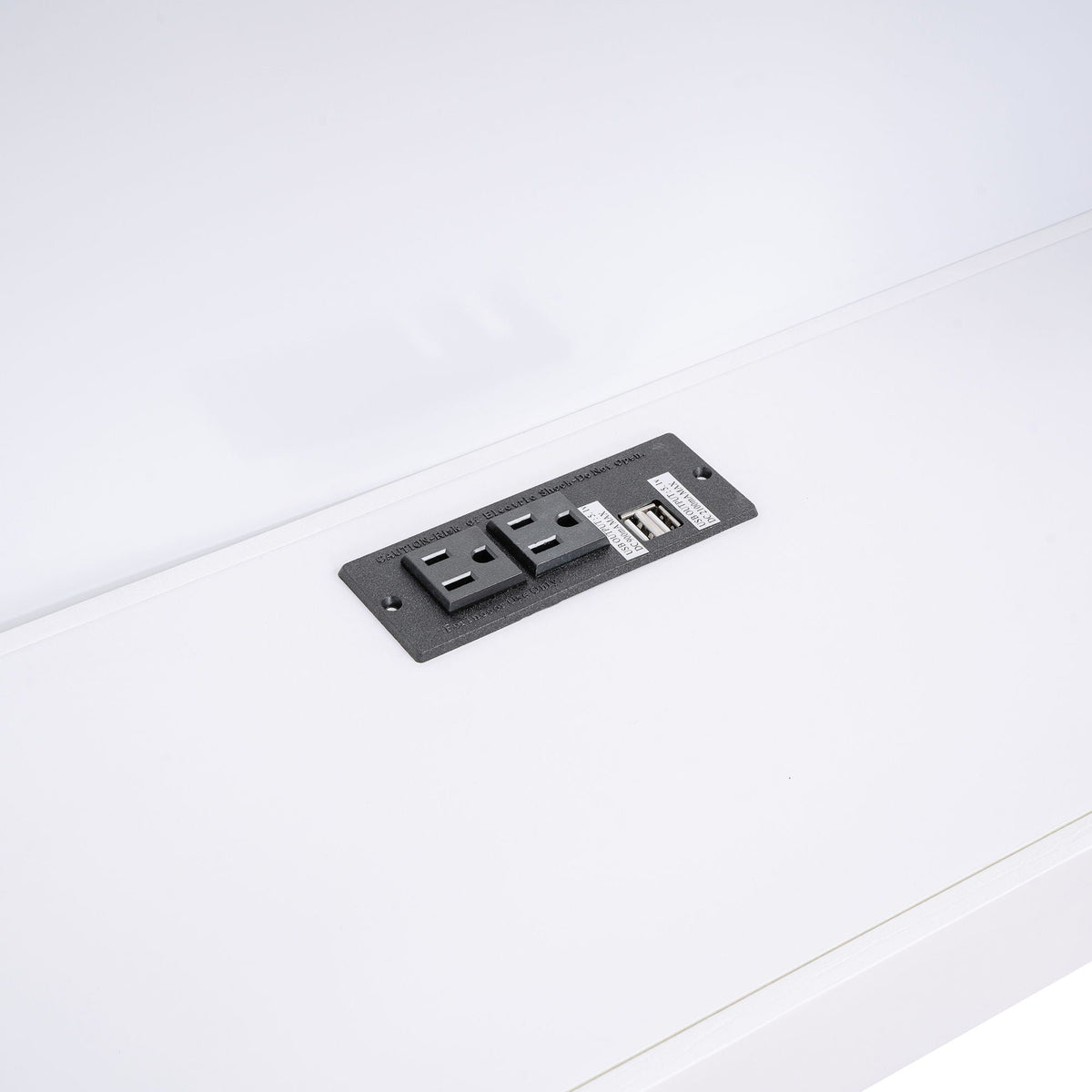 Black electrical outlet plate with USB ports and two outlets on white bed frame surface on Tampa Home & Garden Store