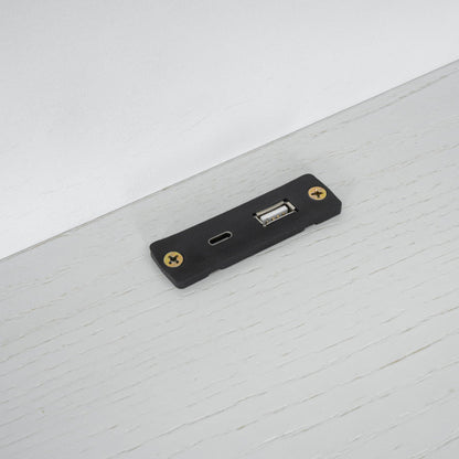Black platform bed mounting bracket with brass screws on light wood surface on Tampa Home & Garden Store