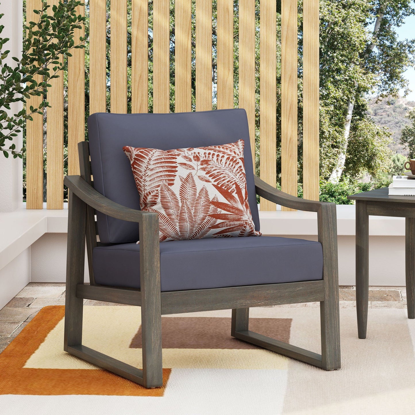 Samwell Outdoor Club Chair by HouseOfZazla with charcoal cushions and wood frame fern pillow on Tampa Home & Garden Store