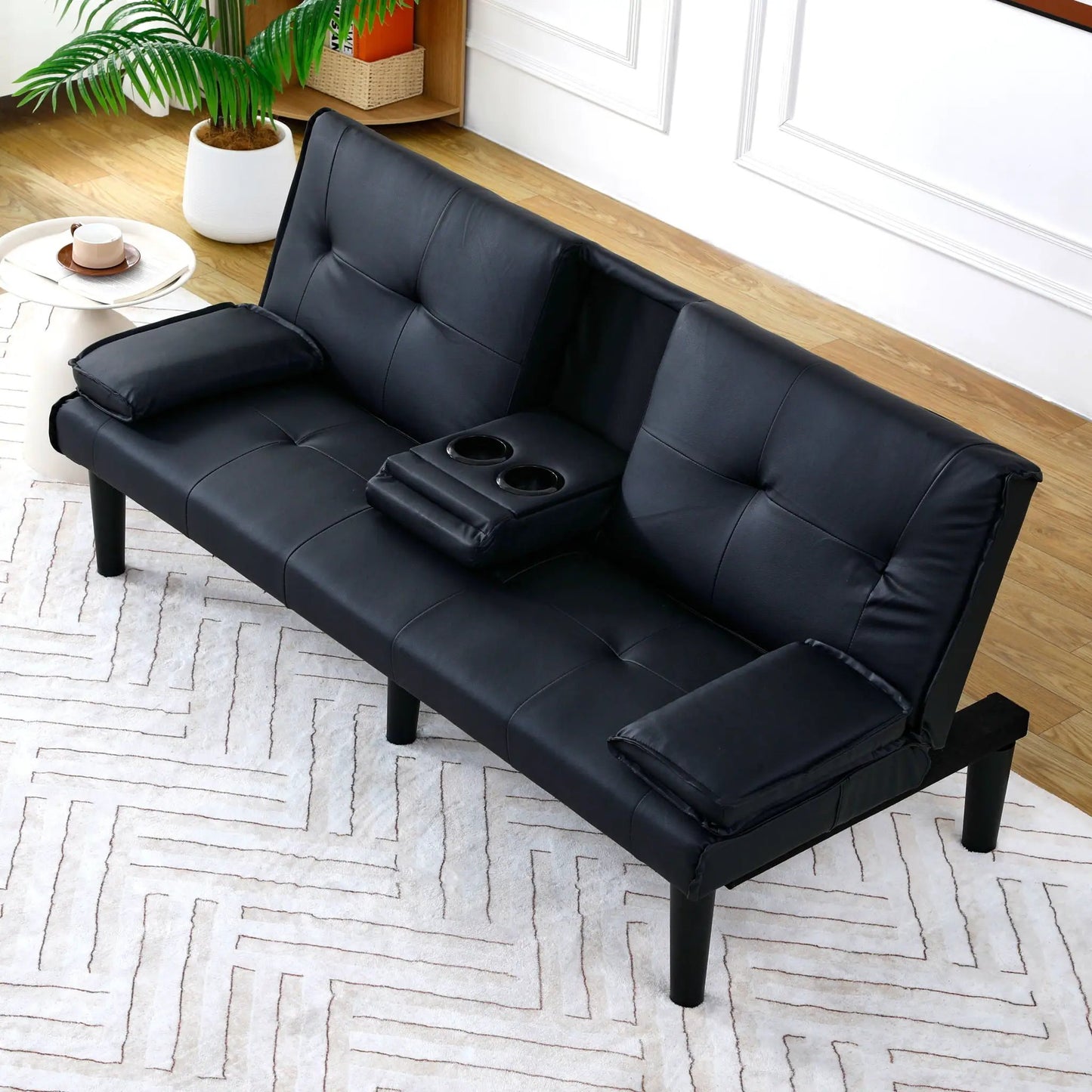 Black faux-leather sofa bed with foldable design and built-in cup holders by Unique Piece Furniture on Tampa Home & Garden Store